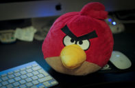 Angry Bird stuffed animal sitting next to keyboard for blog post: What is Anger? A Secondary Emotion
