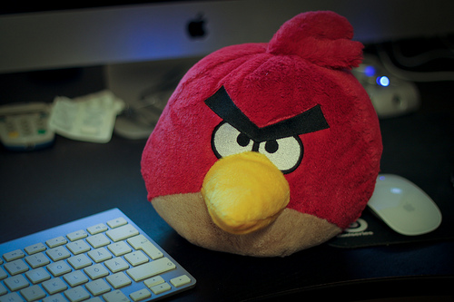 Angry Bird stuffed animal sitting next to keyboard for blog post: What is Anger? A Secondary Emotion