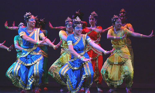 Indian women dancing and looking happy, illustrating that dance can be therapeutic