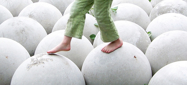 Child balancing on rocks by D. Sharon Pruitt