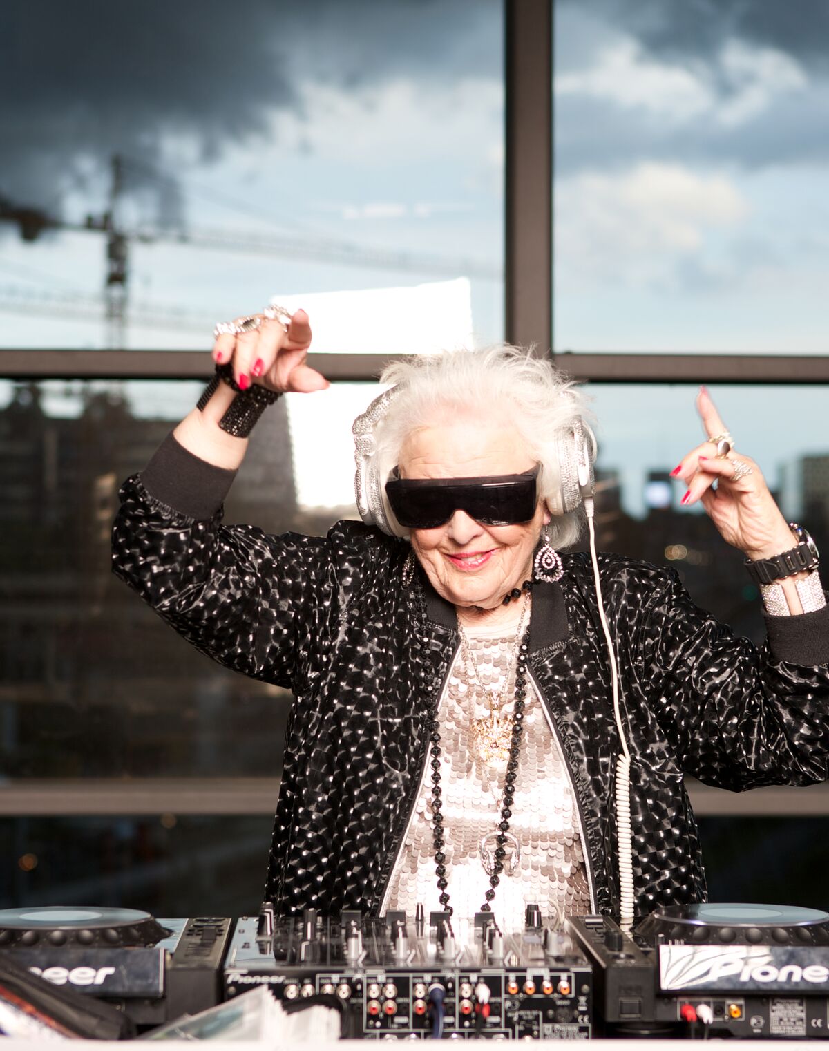 age of happiness, healthy elderly woman ruth flowers having fun as a DJ