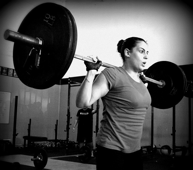 resilience as demonstrated by woman lifting weights