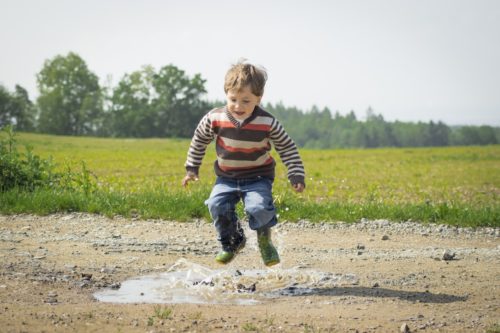Boy jumping and playing, children's mental health