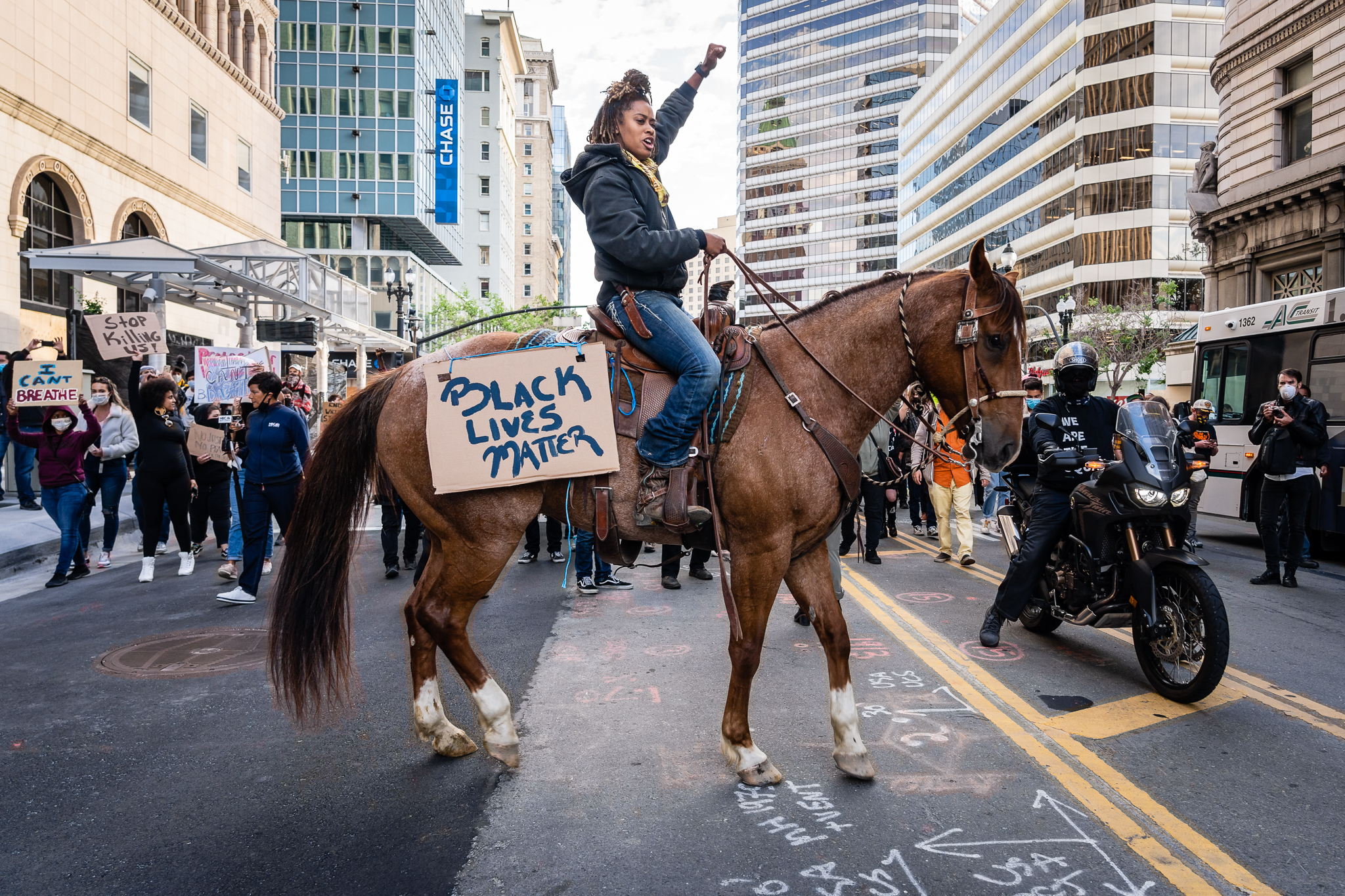 Woman on horse with Black Lives Matters sign at front of march