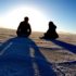 Peaceful image of 2 people sitting by Salt Lake, demonstrating how supporting others helps you support yourself